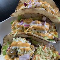 Korean Tacos · 3 warm flour tortillas filled with your choice of meat on a bed of crisp lettuce, seasoned w...
