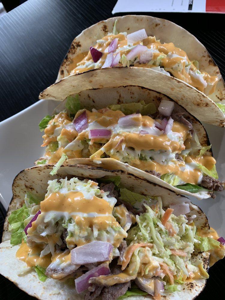 Korean Tacos · 3 warm flour tortillas filled with your choice of meat on a bed of crisp lettuce, seasoned with buttermilk ranch dressing and spicy mayo.
