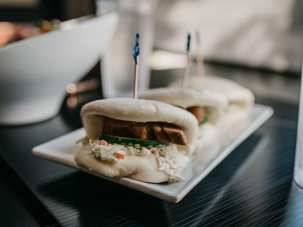 Pork Buns · Steamed wheat buns filled with slices of savory pork belly. Topped with cucumbers, coleslaw, spicy mayo and katsu sauce. Served 3 per order.