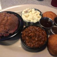 Texas Style Slow Smoked Beef Brisket Dinner · Served with choice of 2 sides and fried biscuits and apple butter.