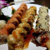 Jin's Roll · Spicy tuna, shrimp & crab with salmon on top.