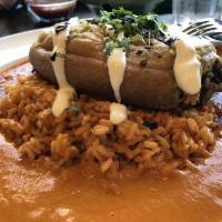 Chile Relleno · Carnitas, cheese, onion and peppers served over guajillo rice. Topped with crema, pasilla ch...