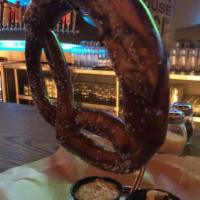Bavarian Pretzel · A giant Bavarian pretzel, salted and served with our house made Guinness grain mustard and B...