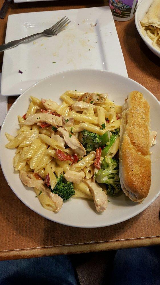 Spicy Chicken & Broccoli Penne Alfredo · Chicken, broccoli, and penne pasta tossed in a creamy Cajun Alfredo sauce with roasted garlic, sun-dried tomatoes, and Parmesan cheese. Served with Parmesan pasta bread. Spicy.