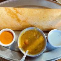Masala Dosa · Thin savory crepe (made with lentil & rice) stuffed with spiced potatoes and peas, served wi...