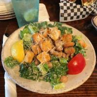 Sid's Caesar Salad · Romaine lettuce, chopped and tossed in a traditional Caesar dressing. Topped with croutons a...