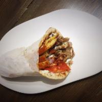 Traditional Pork Gyro · Just like in Greece! 
Hand-stacked marinated pork topped with tomatoes, red onions, and hous...