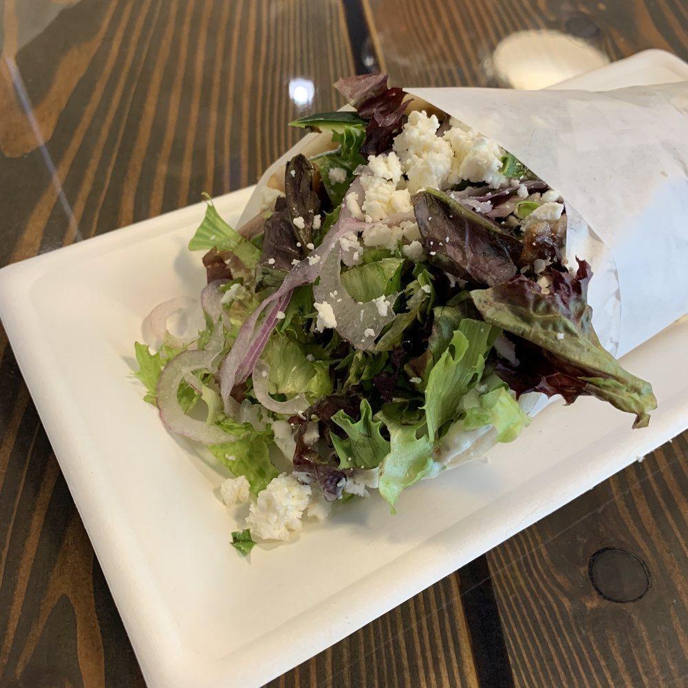 Athena Gyro · Choice of Hand-stacked marinated meats topped with romaine, tomatoes, cucumbers, red onions, crumbled feta and house-made tzatziki.