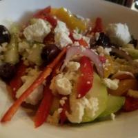 Village Salad · Traditional Greek salad with Roma tomatoes, cucumbers, red onions, bell peppers, Kalamata ol...