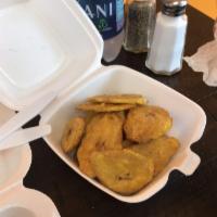 Tostones · Twice fried green plantain.