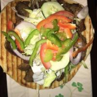 Lamb and Beef Gyro · Lettuce, tomatoes, cucumbers, peppers, onions, and tzatziki sauce.