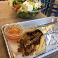 Pork Yeero · Marinated pork layered and broiled to perfection on pita bread with tzatziki sauce, onions a...