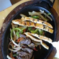 Fajitas · Served with rice, beans, and tortillas, garnished with guacamole, sour cream, and pico de ga...