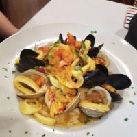 Seafood Risotto · Fresh Maine lobster, wild Maine mussels, gulf shrimp, little neck clams and calamari served ...