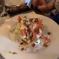 Iceberg Wedge Salad · Slice red onion, vine-ripe tomatoes, applewood bacon and house-made Gorgonzola dressing.