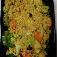 Pineapple Fried Rice · Steamed rice stir-fried with pineapples, egg, carrots, peas, yellow curry powder, raisins an...