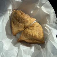 Vegetable Samosa · The unbeatable fried pastry with a savory filling, spiced potatoes, onions, peas in a cone s...
