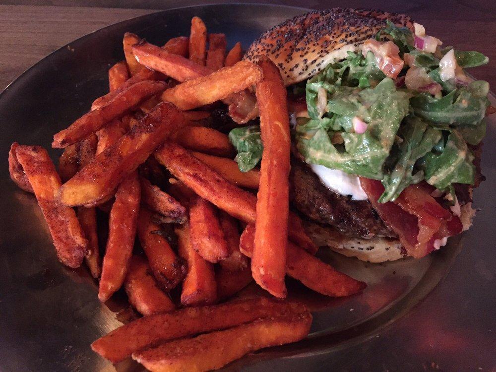 Fresno Fig Burger · Fig marmalade, melted goat cheese, bacon, tomatoes, red onions, arugula, and spicy porter mustard.