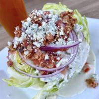 Iceberg Wedge Salad · A crisp wedge of iceberg lettuce, crumbled bleu cheese, red onions, bacon and diced tomatoes...