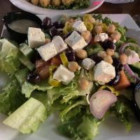 Greek Salad · Romaine lettuce, tomatoes, cucumbers, garbanzo beans, Kalamata olives, red onions, pepperonc...