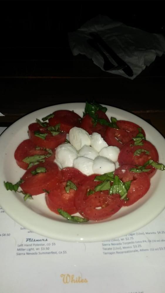 Caprese Salad · Fresh mozzarella and Roma tomatoes dressed with fresh basil and extra virgin olive oil. Gluten-free.