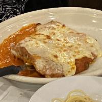 Veal Parmigiana · Served with spaghetti and tomato sauce.