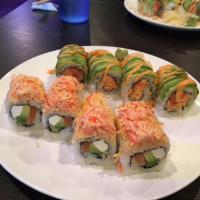 Tokyo Roll · Salmon, avocado, cream cheese inside and spicy crab on top.