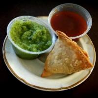 Samosa · Triangular, fried pastry filled with potatoes, peas, and spices for flavor. Served with chil...