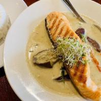 Salmon Green Curry · Grilled salmon served in green curry with bell pepper, eggplant, and basil. Served with jasm...