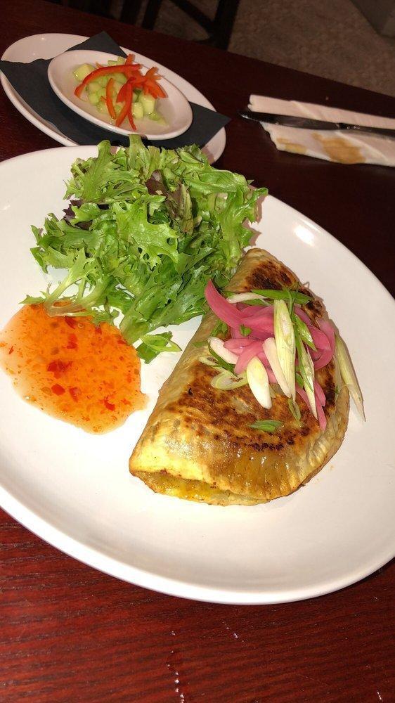 Half Moon Turnover · Curried chicken, onion, potato, oyster sauce, wrapped in paratha. Served with Thai-style pickled salad.