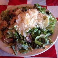 Caesar Salad · A Roman classic with leafy greens, shaved Parmesan cheese and croutons. Tossed in classic Ca...