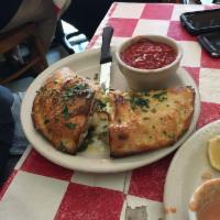 Calzone · Ricotta cheese, mozzarella cheese and Italian sausage. Served with a side of red sauce. Plea...