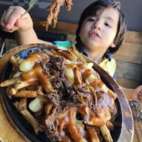Poutine · House cut fries, squeeky cheese curds, and demi-glace.