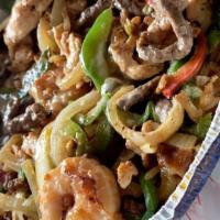 Texas Rice · A bed of rice topped with steak, grilled chicken and shrimp, grilled bell peppers, onions, t...