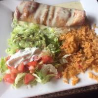 Chimichanga · Flour tortillas deep fried, filled with shredded beef or chicken. Topped with lettuce, tomat...