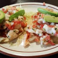 Ceviche · Lime marinated shrimp and fish. Sprinkled with herbs, pico de gallo and sliced avocados tort...