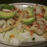 Ceviche Tostadas · 2 lime and herb marinated shrimp and fish on crispy tostadas with avocado.
