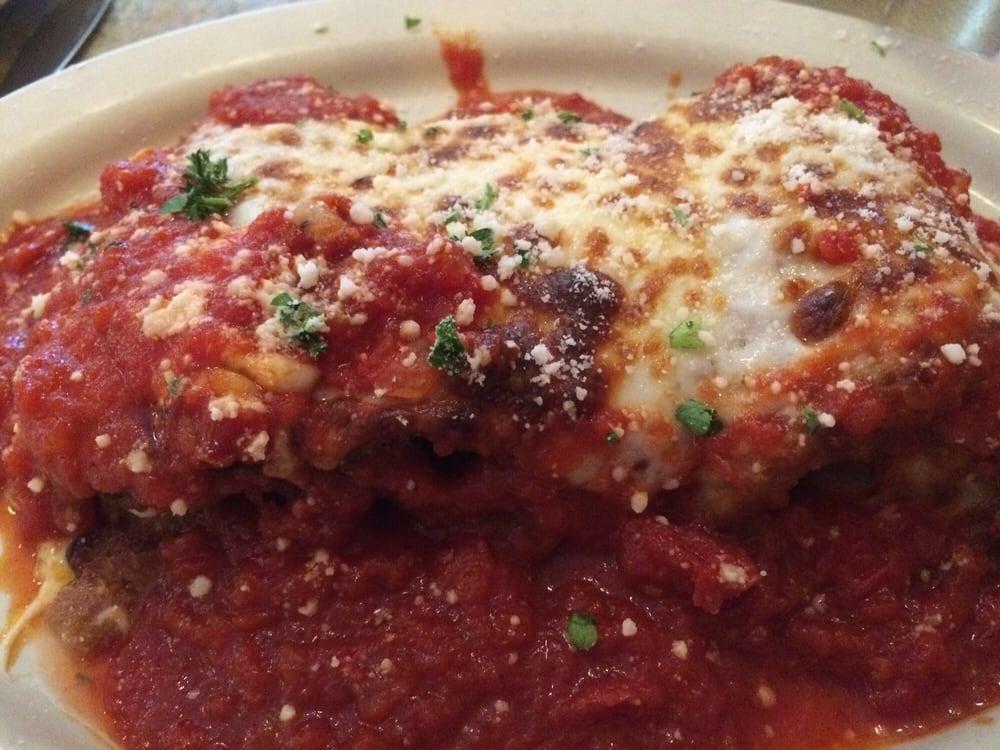 Eggplant Rollatini · Eggplant lightly breaded and fried; layered with ham, provolone and ricotta cheese; rolled up and baked in tomato sauce with mozzarella cheese.