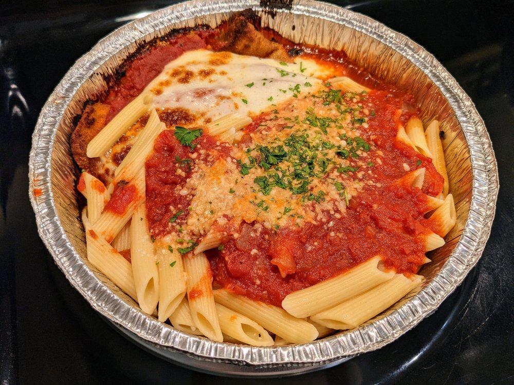 Eggplant Parmigiana · Eggplant lightly breaded, fried and baked in tomato sauce with mozzarella cheese served with a side of penne pasta with tomato sauce.