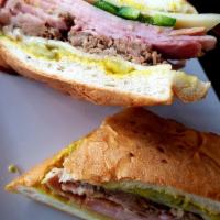 The Cohiba Havana Sandwich · Mojo roasted pork, black forest ham, Swiss, pickles, mustard, and jalapenos.