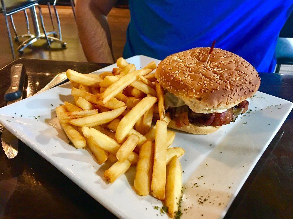 BBQ Burger · 1/2 pound angus burger topped with BBQ sauce, Mozzarella cheese, bacon and sauteed onions. Served with fries.