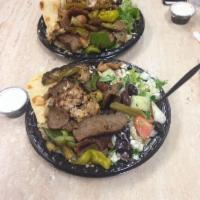 Combination Plate · Gyros with your choice of chicken or beef. Served with rice, Greek salad, pita bread and tza...
