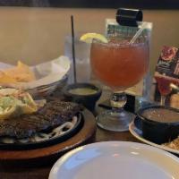 Carne Asada · Certified black Angus outside skirt grilled to perfection. Served with rice, charro beans,pi...