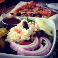 Greek Salad · Romaine, feta, cucumber, kalamata olives, tomatoes, peperoncinis, and red onions.
