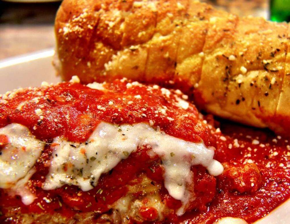 Lasagna · Fresh Pasta Layered With Italian Sausage And Beef, Ricotta Cheese, our Homemade Marinara Sauce, And Baked Mozzarella And Romano Cheese. Served with a side of garlic bread.