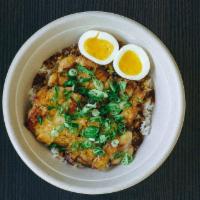 Adobo Bowl · Braised pork belly, adobo sauce, soft boiled egg, scallions and rice.