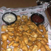 Rosti's Dough Nuggets · Bite-sized pieces of crispy pizza dough tossed in garlic butter sauce and served with a side...