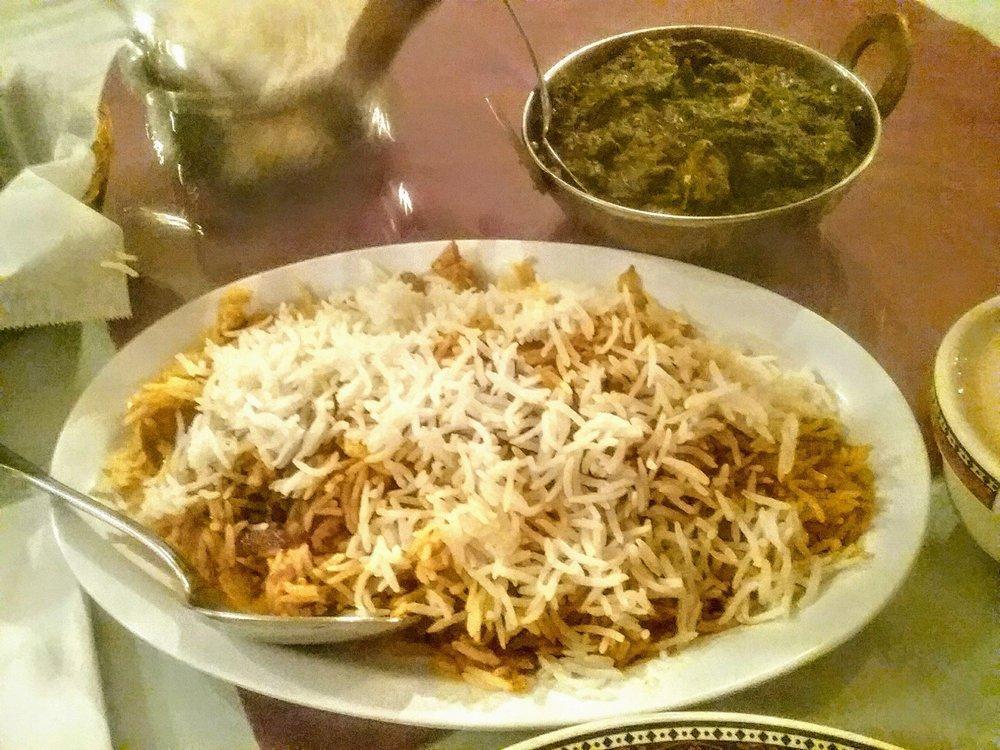 Chicken Biryani · Basmati rice cooked with special blend of herbs and spices and served with raita.
