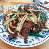 Mongolian Beef · Sliced beef stir-fried and smothered in white and green onions.