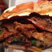 Torta Picosa · Smoked ham, tinga steak, spicy pork, cilantro, onions and hot sauce. Served with oaxaca chee...